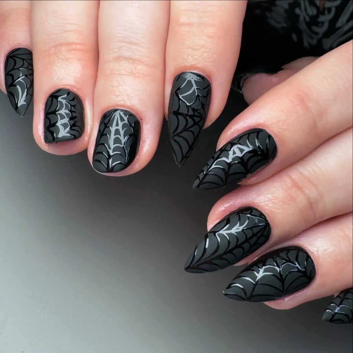 Black stiletto press-on nails with white spider web nail art design, handmade and reusable