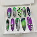 Halloween press-on nails set with purple, green, black stripes, glitter and spiderweb charms