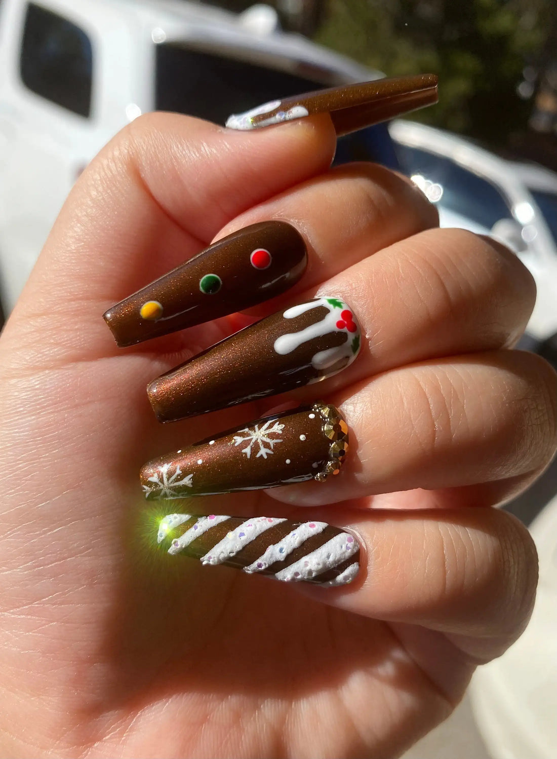 Brown Christmas gingerbread-themed press-on nails with snowflakes and candy cane designs.