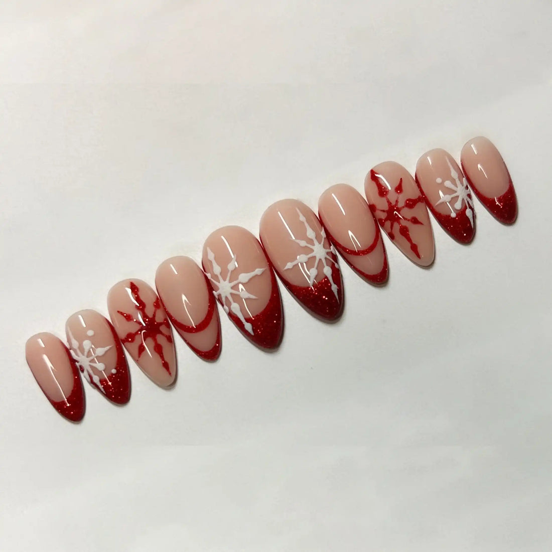 Red French tip press-on nails with white snowflake designs, holiday handmade fake nails