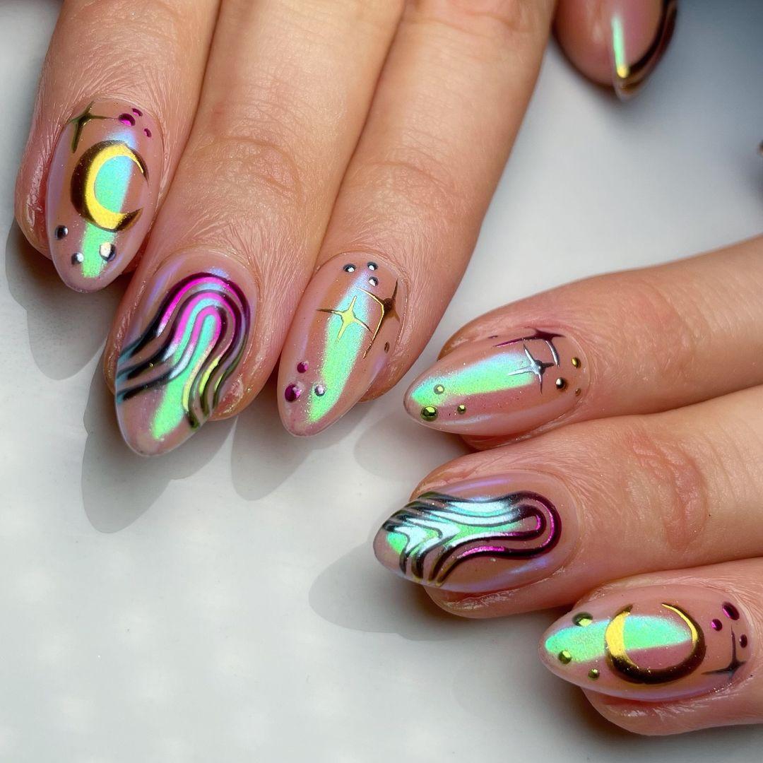Hand with iridescent chrome press-on nails featuring abstract line and dot designs.
