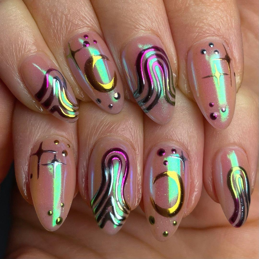Hand with iridescent chrome press-on nails featuring abstract line and dot designs.