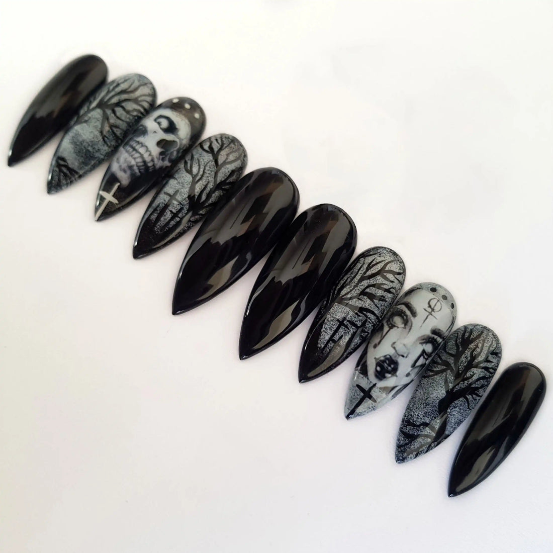 Black Halloween press-on nails with skull, witch, and spooky tree designs