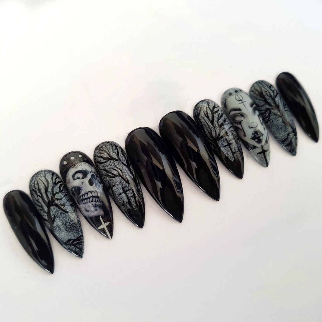 Black Halloween press-on nails with skull, witch, and spooky tree designs