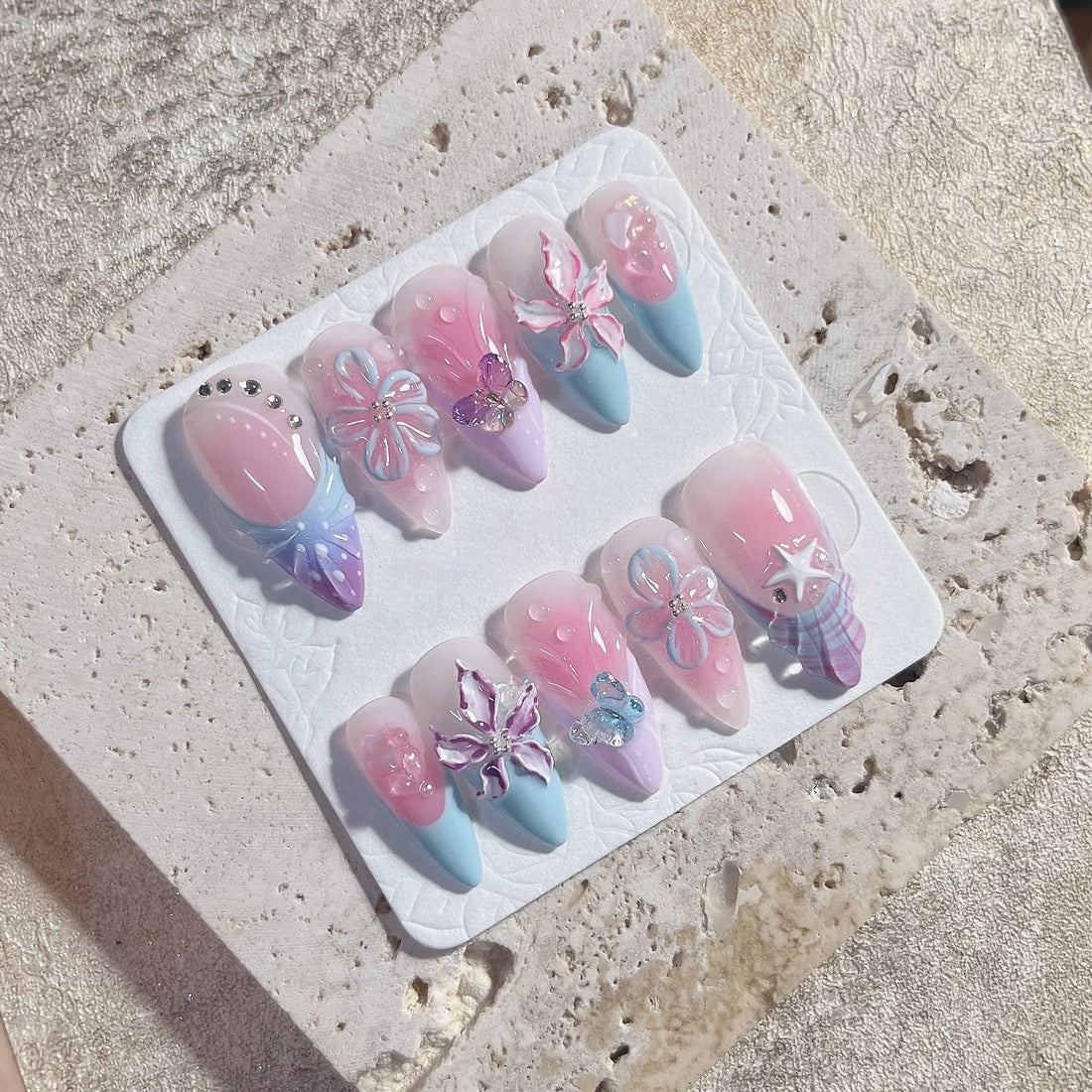 Handmade pastel press-on nails with 3D butterfly, floral, and ribbon bow designs