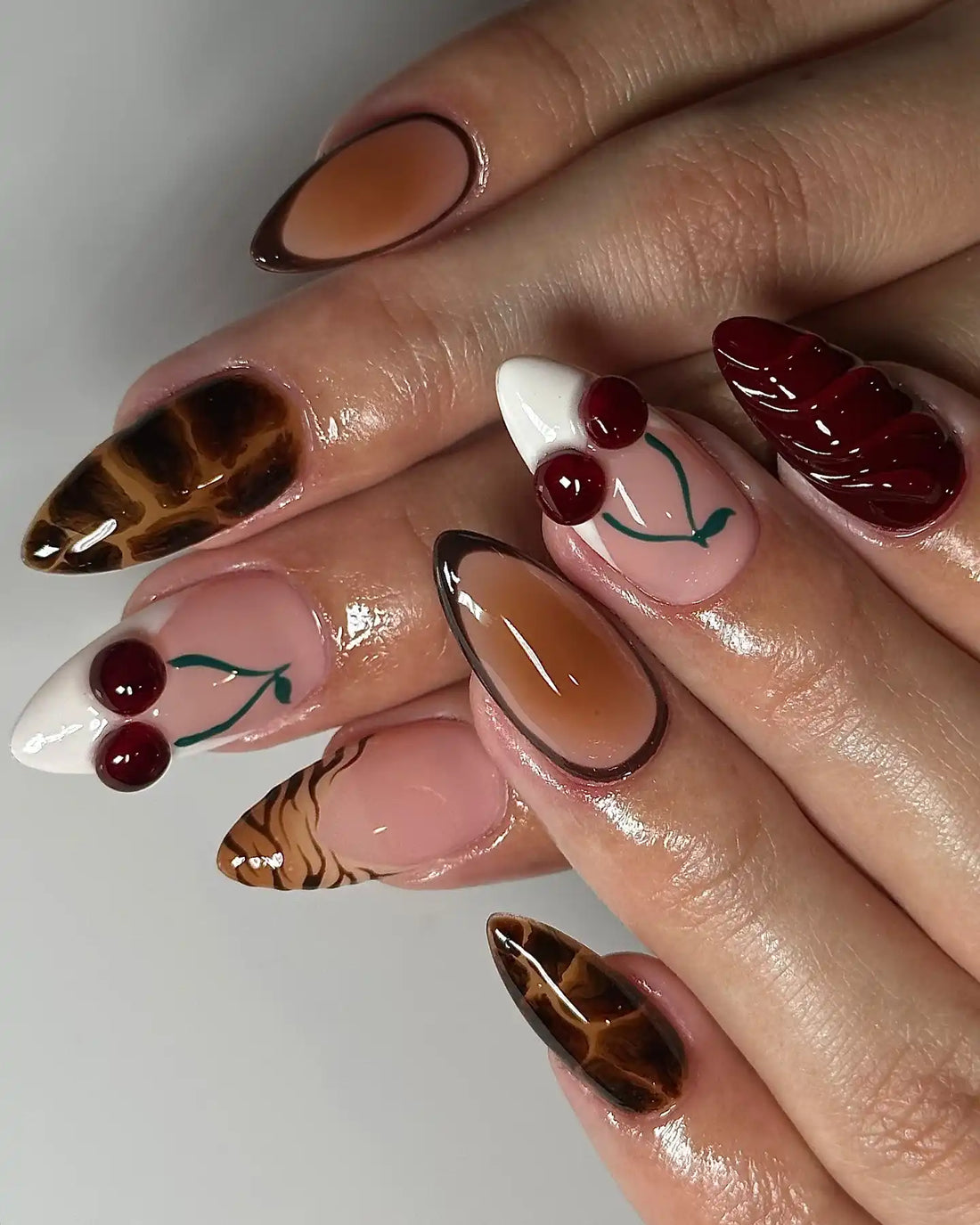 Handmade 3D press-on nails with cherry accents, chocolate brown, and tortoise shell animal print.