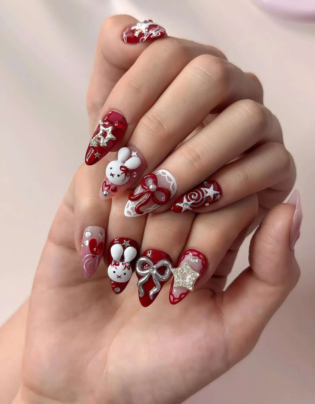 Handmade red press-on nails with 3D bunny, bow, and star kawaii holiday designs