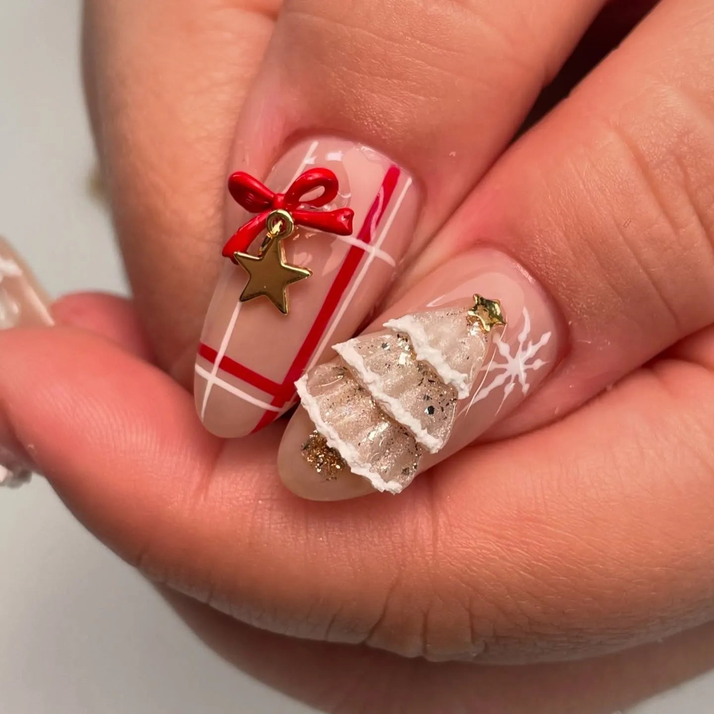 Handmade Christmas press-on nails with 3D tree, red bow, star charm, and festive designs.