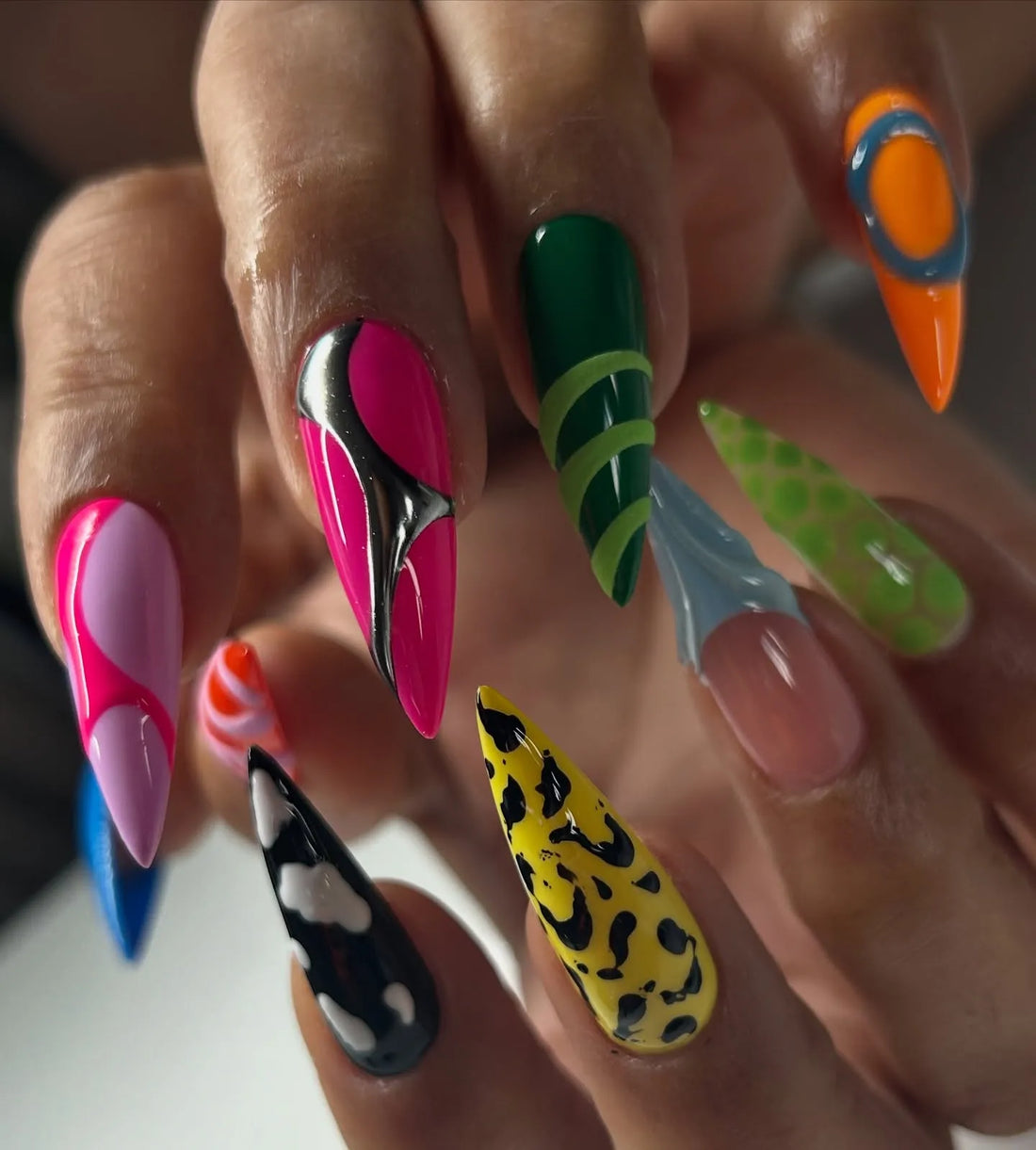Handmade stiletto press-on nails with neon, abstract, 3D, and animal print designs.