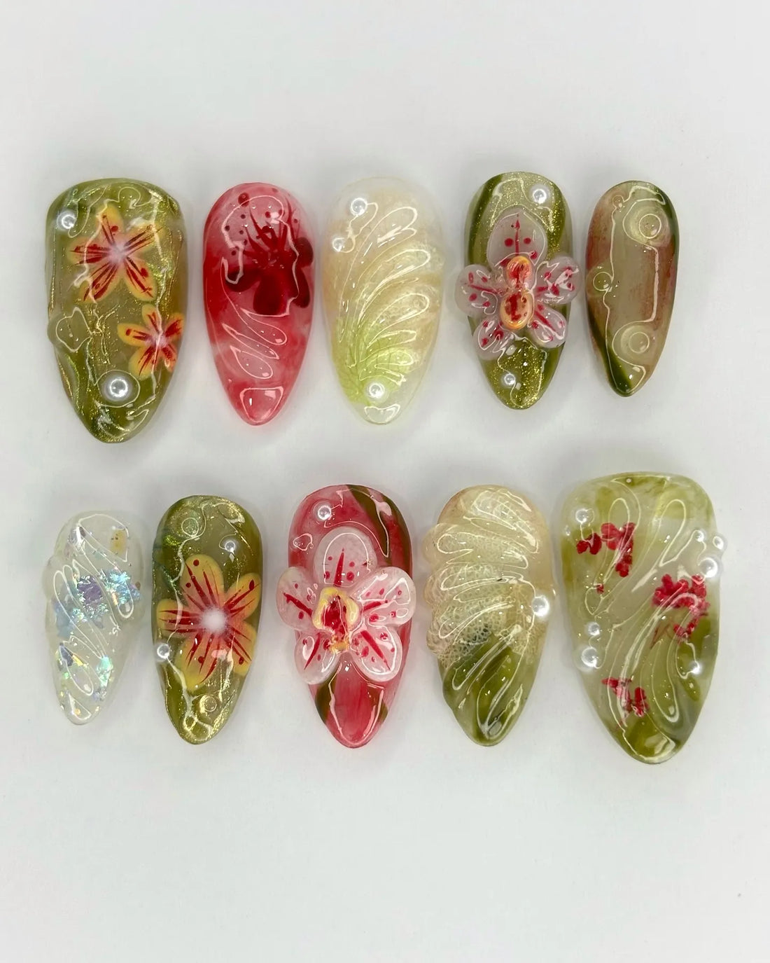 Handmade press-on nails with 3D pink orchid floral design, green and gold accents, and pearl details