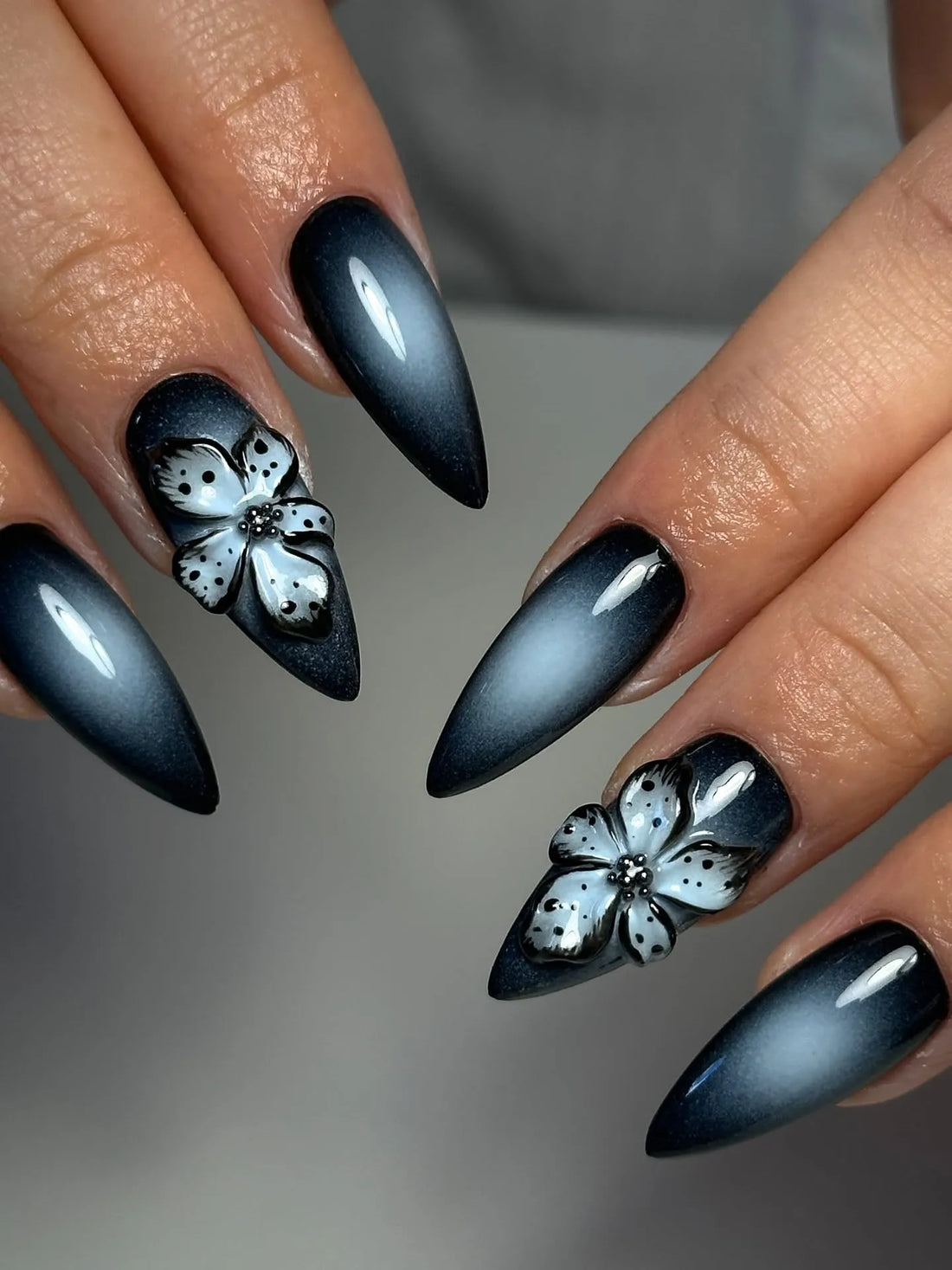 Handmade black press-on nails with 3D floral design and glossy ombre finish