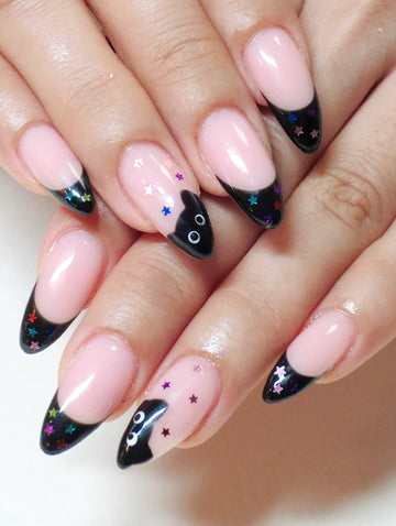 Handmade press-on nails with black French tips, colorful star accents, and black cat design.