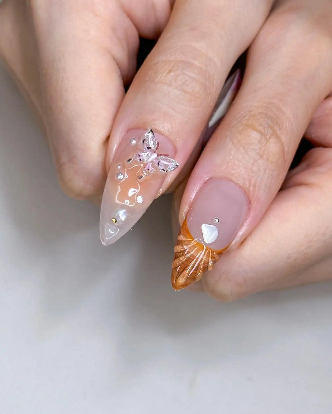 Handmade press-on nails with 3D butterfly, flower accents, and pastel mermaid designs