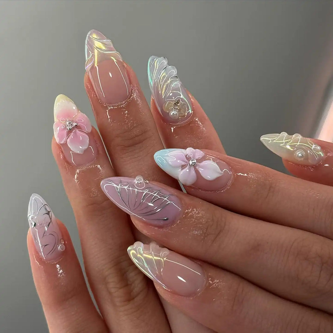 Handmade silver butterfly 3D press-on nails with iridescent and pink flower designs