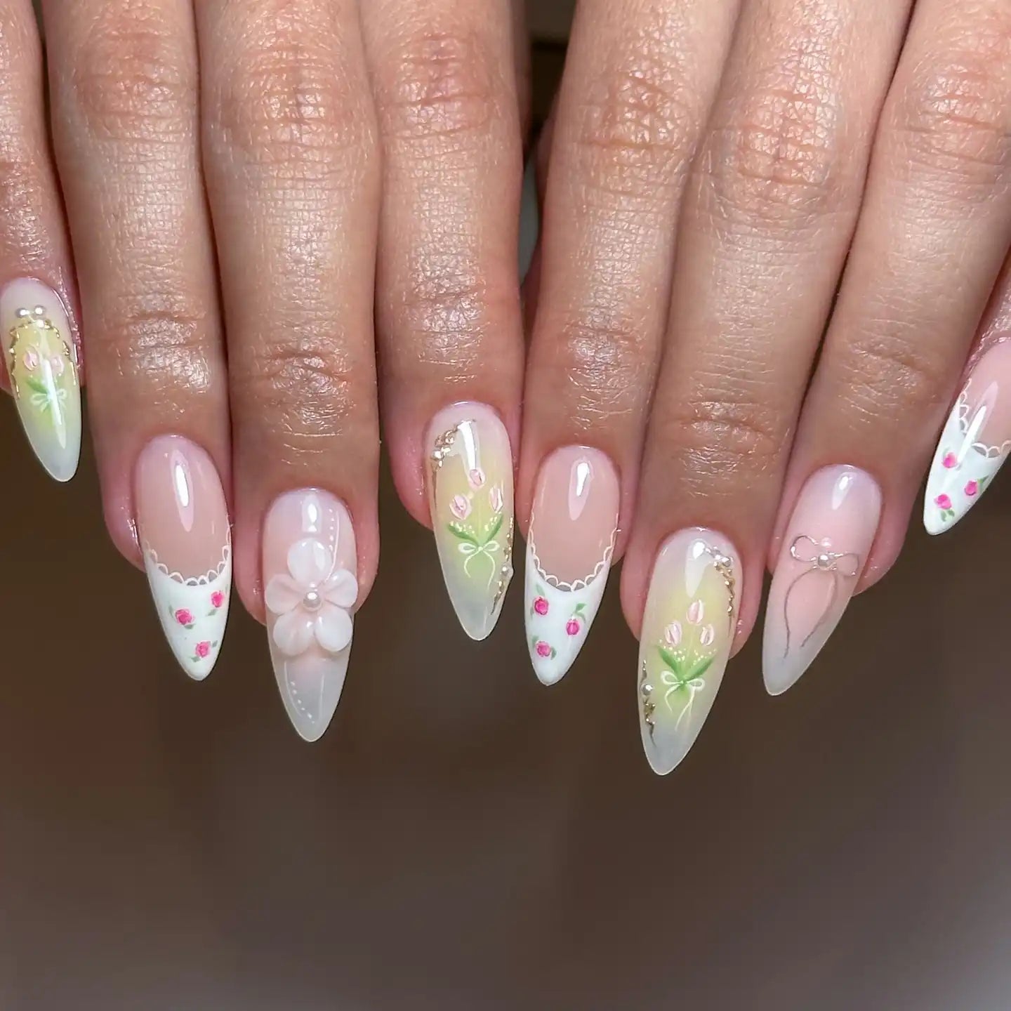 Handmade press-on nails with French tips, floral and strawberry designs, pastel colors, 3D flower accent.