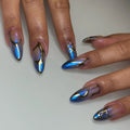 Hand with long almond-shaped blue chrome metallic press-on nails with cyberpunk abstract gold accents