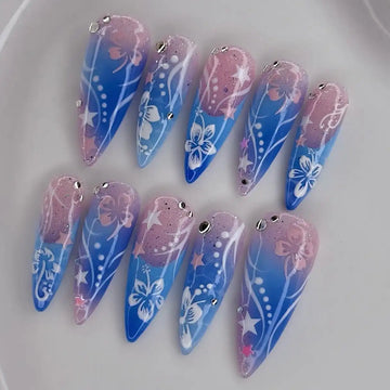 Handmade blue and pink ombre press-on nails with floral hibiscus and star designs