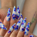 Handmade stiletto press-on nails with blue and purple floral watercolor art and gold accents