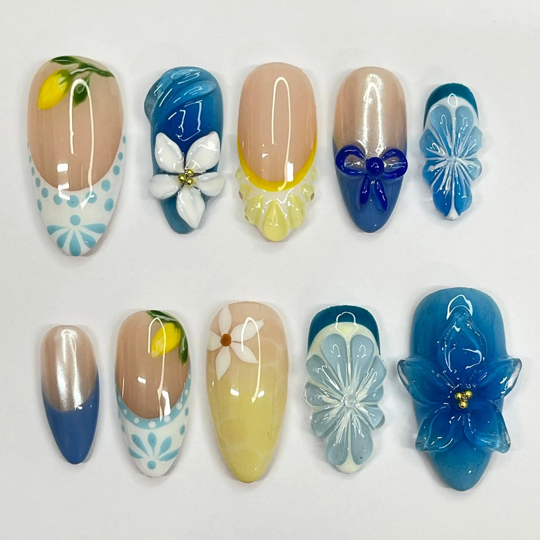 Handmade blue and yellow floral summer press-on nails with 3D lemon and flower designs.