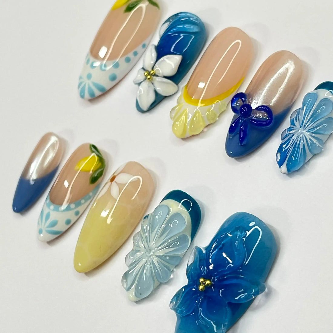 Handmade blue and yellow floral summer press-on nails with 3D lemon and flower designs.