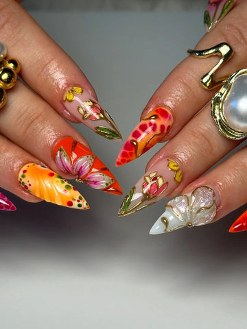 Handmade press-on nails with bold red, orange, and gold 3D floral and butterfly designs.