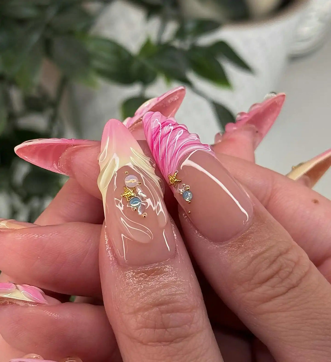 Handmade press-on nails with pink 3D floral and seashell designs, crystal accents, glossy finish.