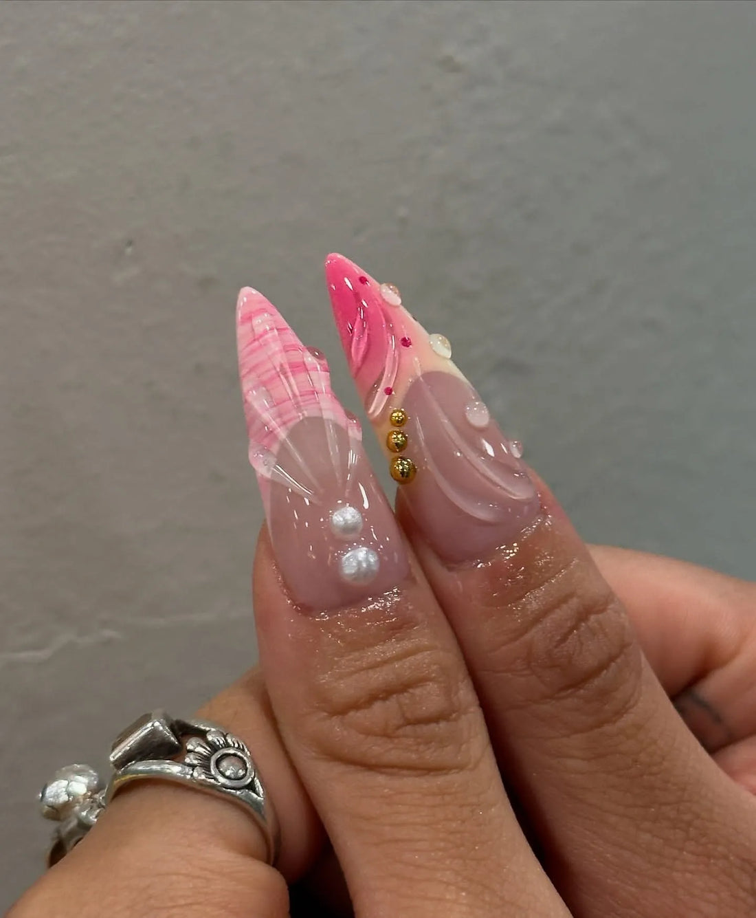 Handmade bubblegum pink stiletto press-on nails with 3D floral designs and gold accents