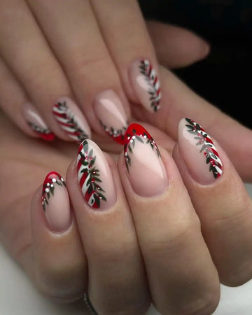 Handmade Christmas press-on nails with candy cane stripes and holly leaf nail art.