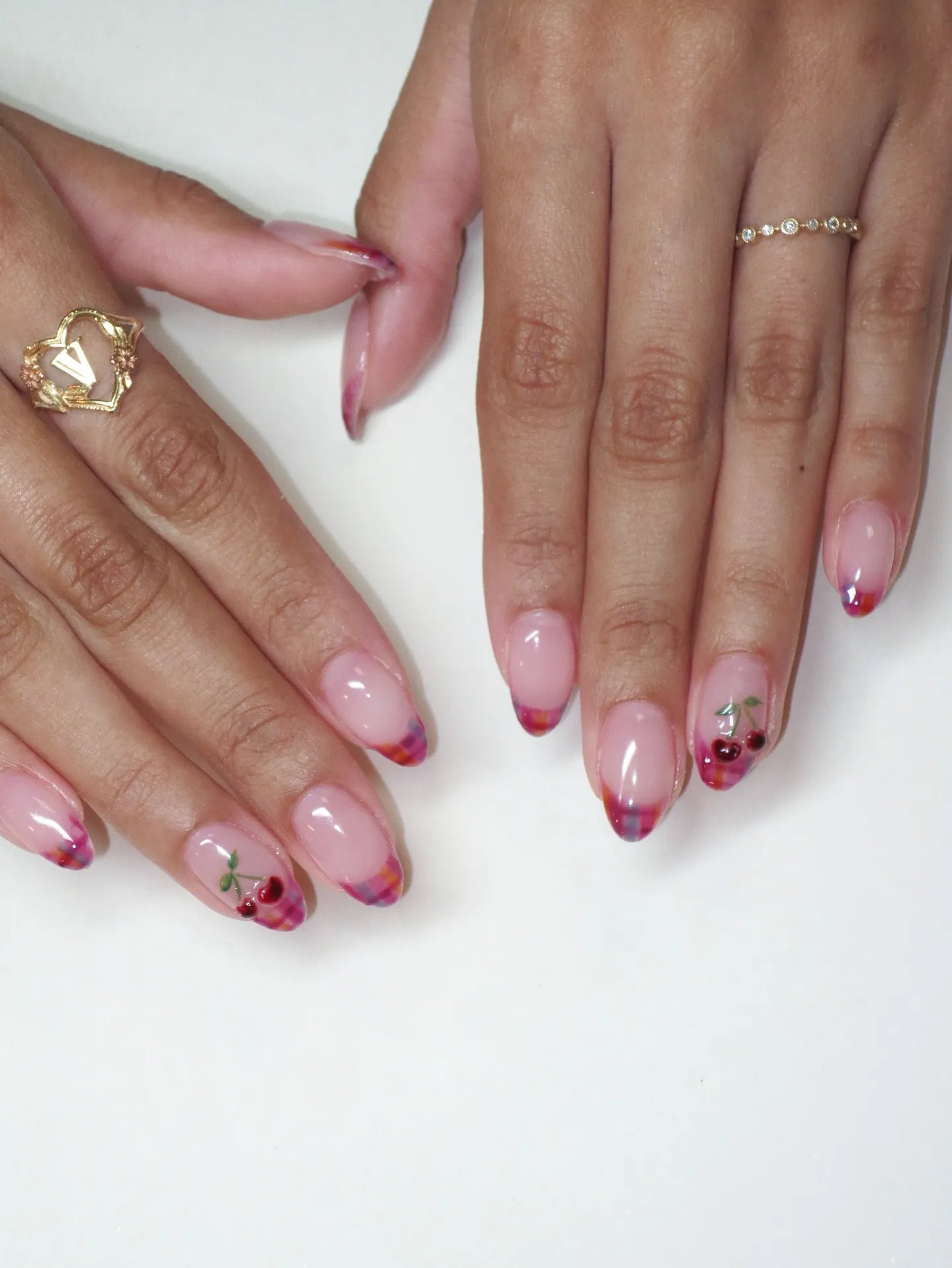 Handmade press-on nails with pink plaid French tips and cherry fruit nail art design