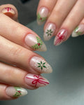 Handmade press-on nails with Christmas ribbon, holly berries, and snowflake designs