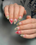 Handmade press-on nails with Christmas designs, holly berries, bows and snowflakes.