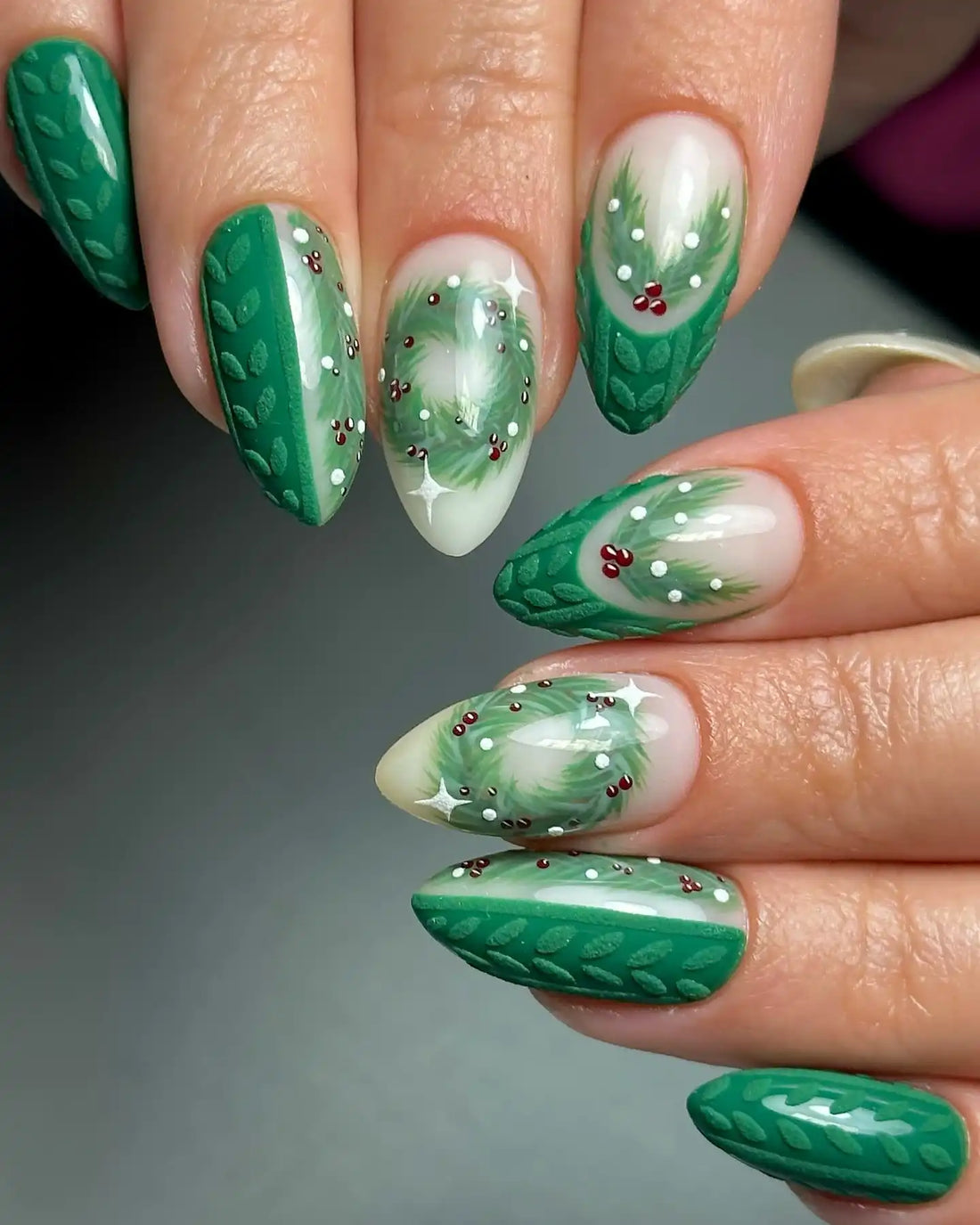 Green handmade Christmas press-on nails with holly berries and wreath nail art.