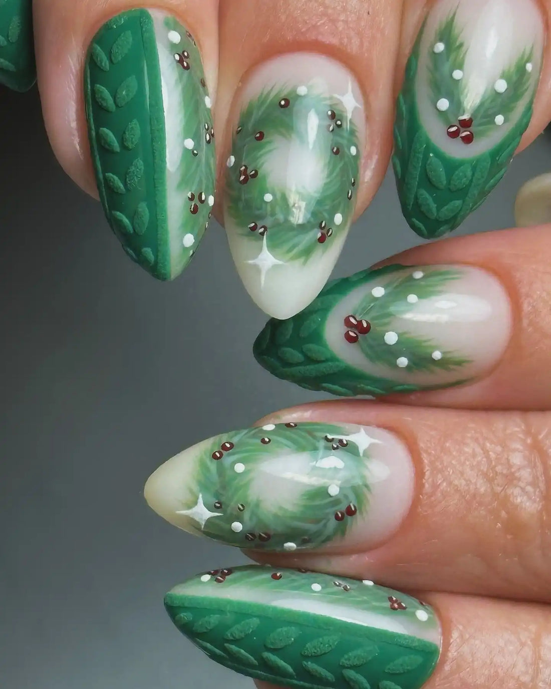 Green handmade Christmas press-on nails with holly berries and wreath nail art.