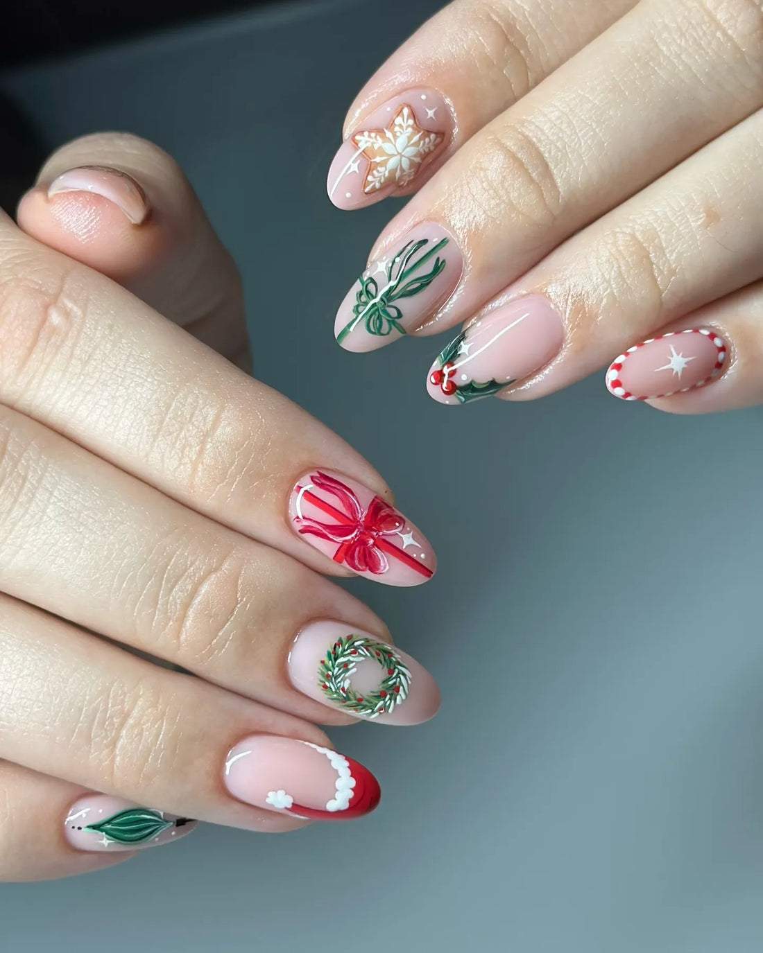Handmade Christmas press-on nails with snowflake, holly, red bow, and festive wreath designs