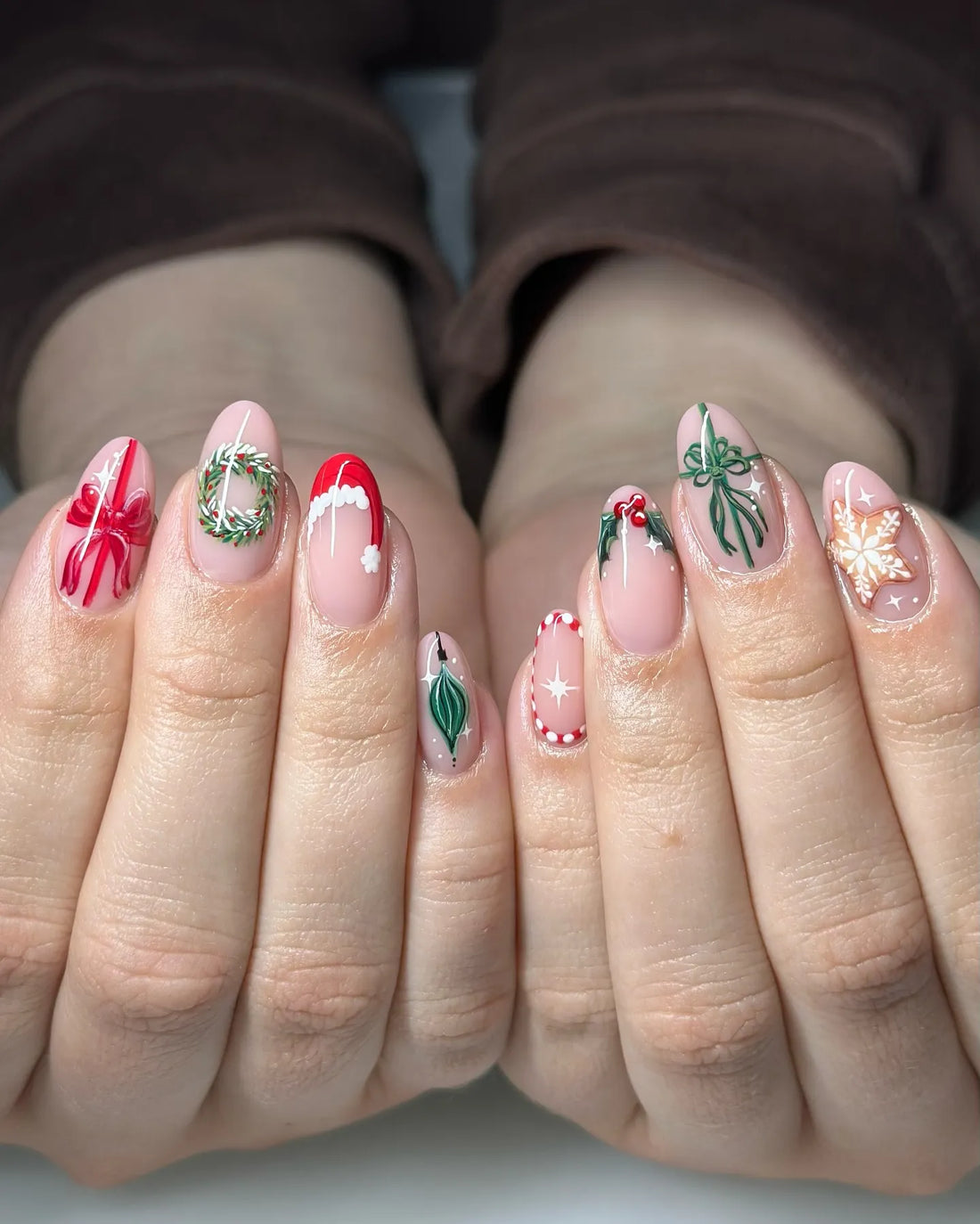 Handmade Christmas press-on nails with snowflake, holly, red bow, and festive wreath designs