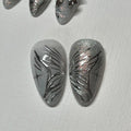 Handmade chrome silver press-on nails with abstract butterfly wing design