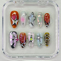 Handmade Y2K press-on nails with metallic chrome stars, swirls, floral and animal print designs.