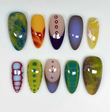 Handmade colorful graffiti press-on nails with abstract and geometric patterns on white background