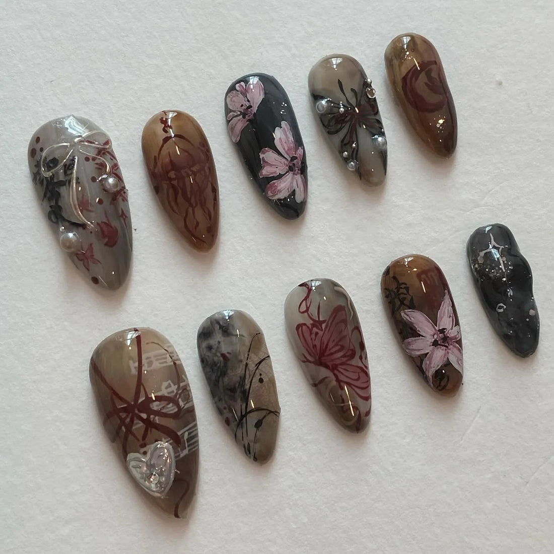 Handmade dark academia press-on nails with floral, butterfly, and moody brown gray designs