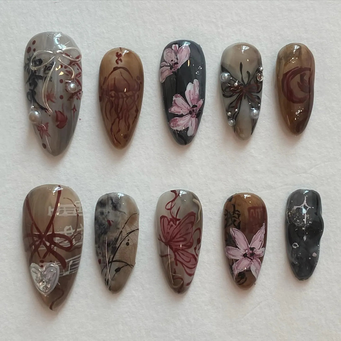 Handmade dark academia press-on nails with floral, butterfly, and moody brown gray designs