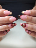 Handmade press-on nails with dark cherry floral design, tiger print French tips, and gold accents.