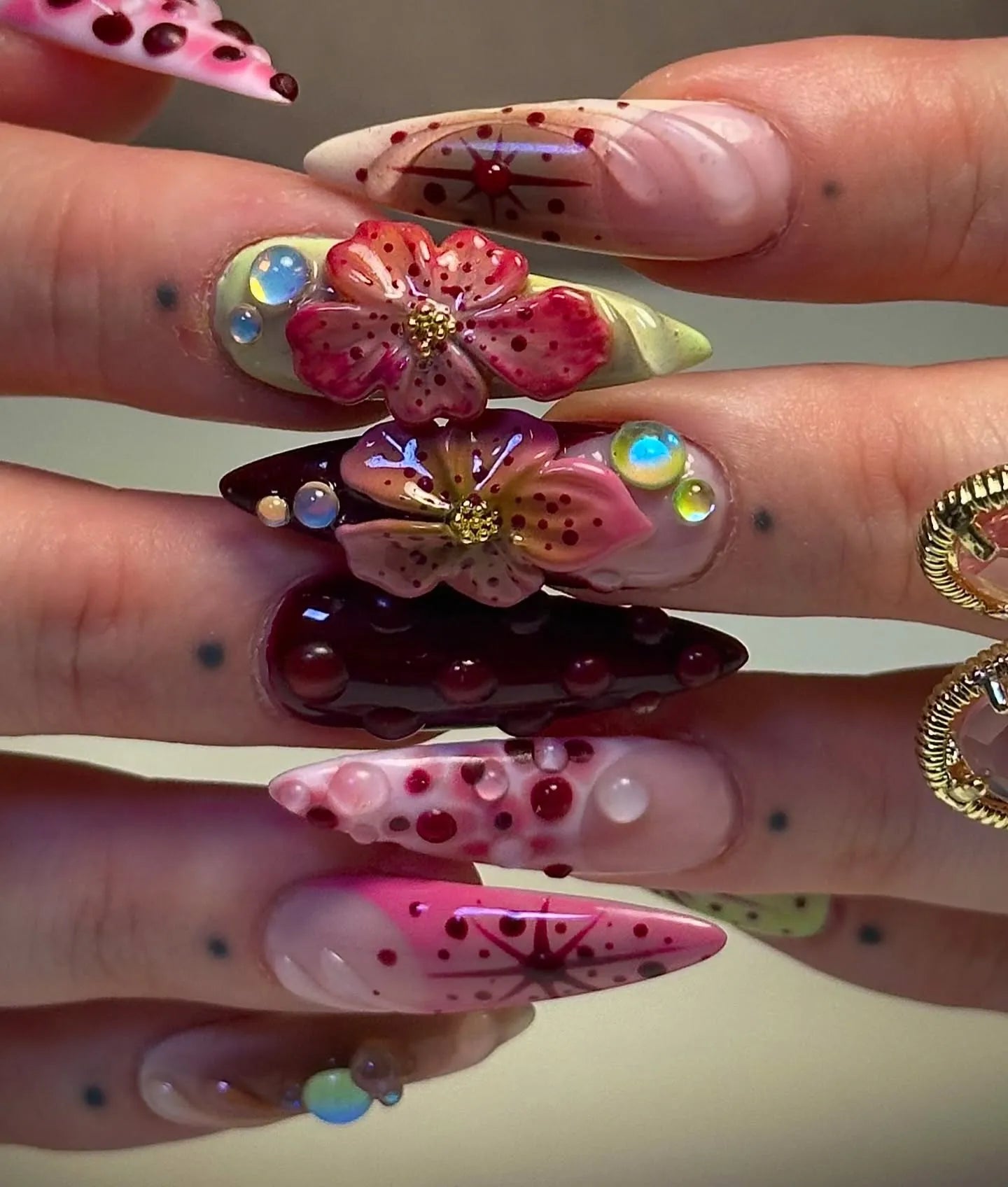 Handmade deep red 3D floral press-on nails with gemstone and artistic designs