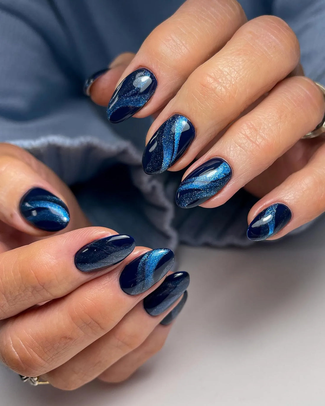 Handmade navy blue galaxy cat eye press-on nails with velvet shimmer finish