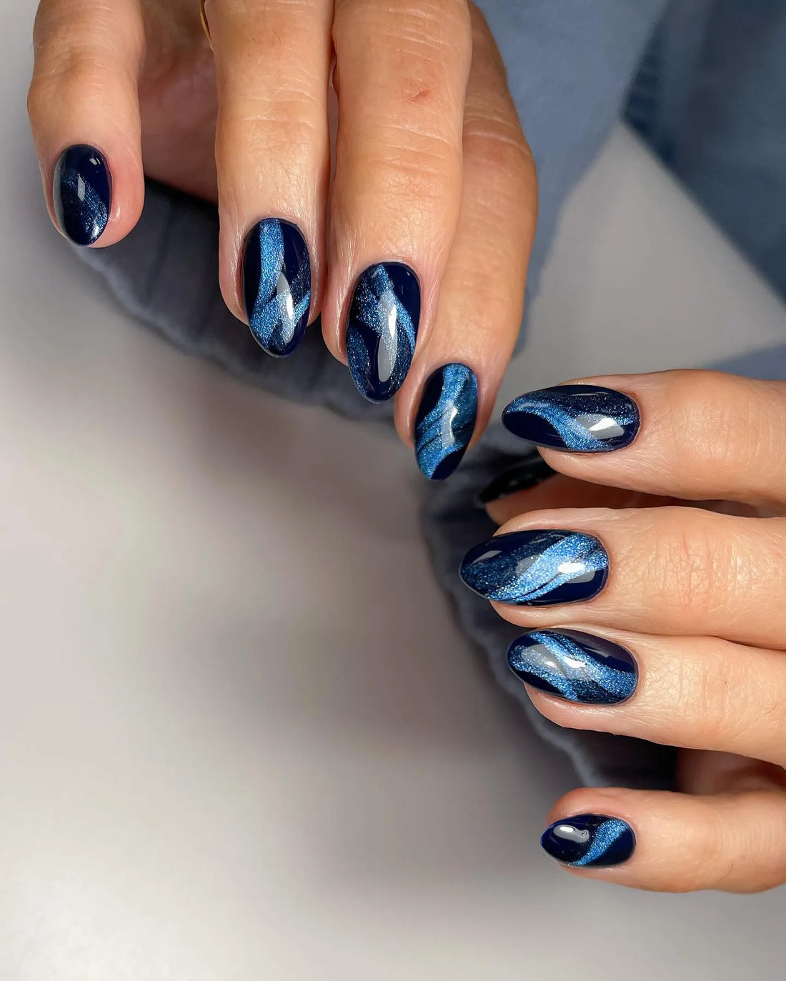 Handmade navy blue galaxy cat eye press-on nails with velvet shimmer finish