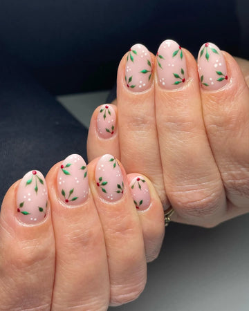 Handmade nude press-on nails with holly leaf, red berry, and white snow dot winter design