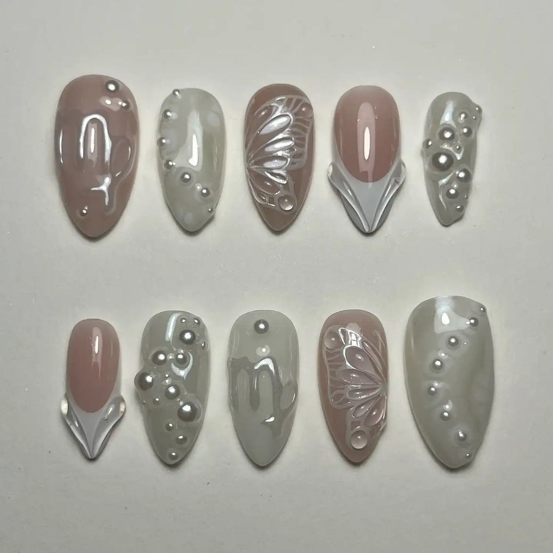 Handmade ivory and white press-on nails with pearl and butterfly designs, bridal style