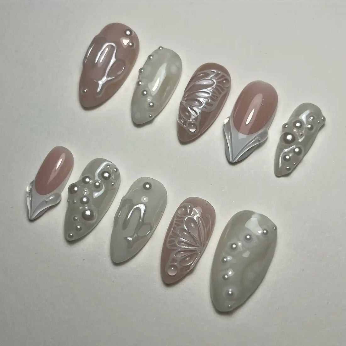 Handmade ivory and white press-on nails with pearl and butterfly designs, bridal style