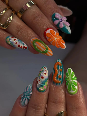 Handmade press-on nails with colorful abstract swirl, floral, and fruit summer designs.