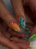 Handmade press-on nails with colorful abstract flower and swirl fruit designs