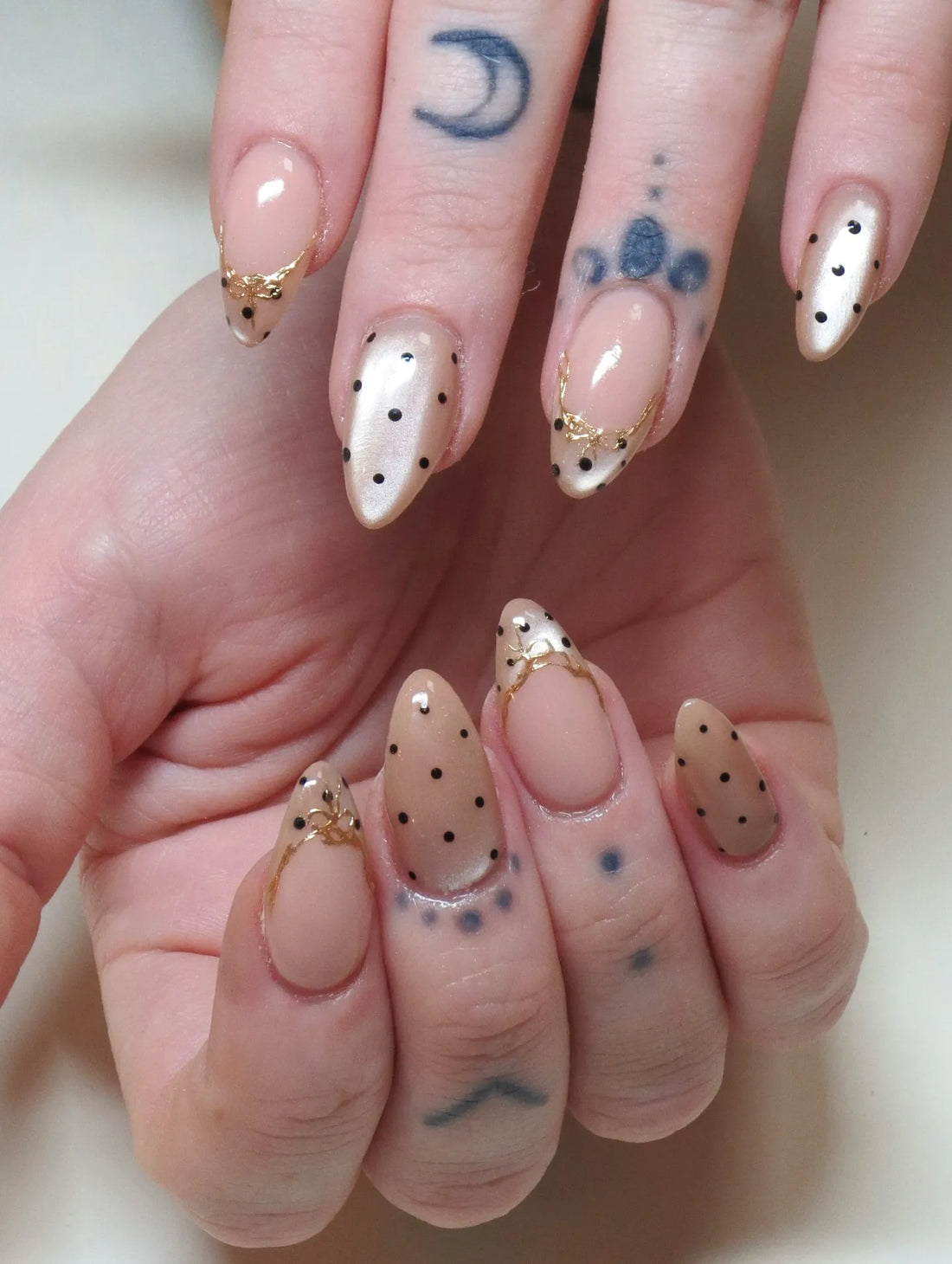 Handmade almond-shaped press-on nails with gold filigree and pearlescent polka dots